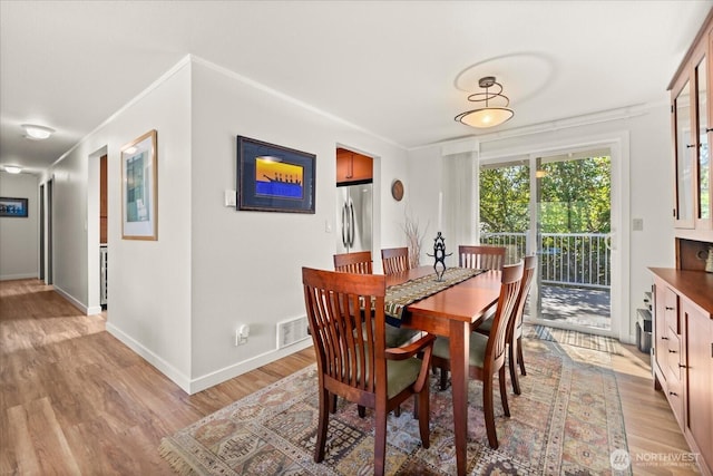 9 199th Pl SE, Bothell, WA 98012 - dining space featuring light wood-type flooring, baseboards, and crown molding