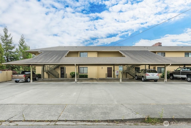 310 S 11th St Unit 106, Mount Vernon, WA 98274 - view of property featuring stairs and covered parking