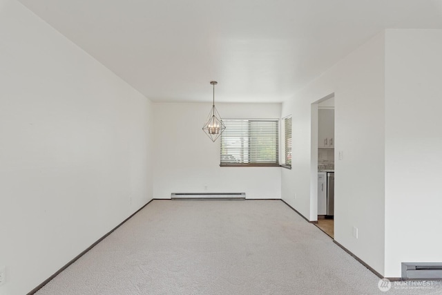 310 S 11th St Unit 106, Mount Vernon, WA 98274 - unfurnished room with a chandelier, light colored carpet, and a baseboard heating unit