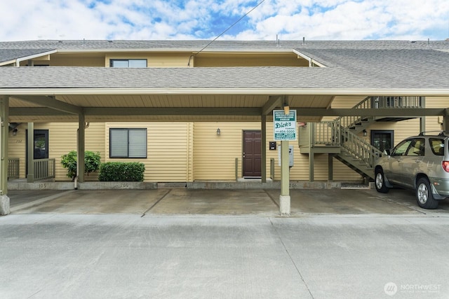 310 S 11th St Unit 106, Mount Vernon, WA 98274 - view of front of property with roof with shingles, stairs, and covered parking