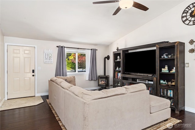 7606 Illahee Rd NE, Bremerton, WA 98311 - living area with a wood stove, baseboards, ceiling fan, dark wood-type flooring, and vaulted ceiling