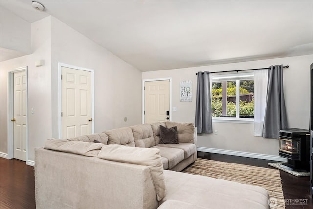 7606 Illahee Rd NE, Bremerton, WA 98311 - living area featuring a wood stove, dark wood-style flooring, lofted ceiling, and baseboards
