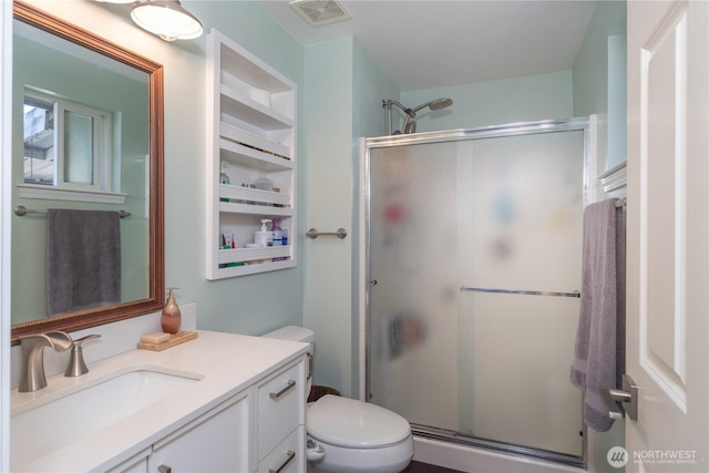 7606 Illahee Rd NE, Bremerton, WA 98311 - full bath featuring vanity, a shower stall, toilet, and built in shelves