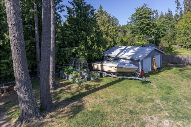 7606 Illahee Rd NE, Bremerton, WA 98311 - view of yard with a garden, a garage, an outdoor structure, and a wooded view