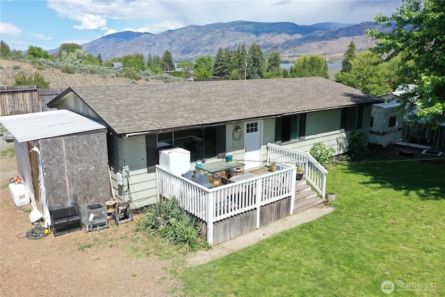6 Elgin Way, Oroville, WA 98844 - rear view of property with roof with shingles, a yard, and a mountain view