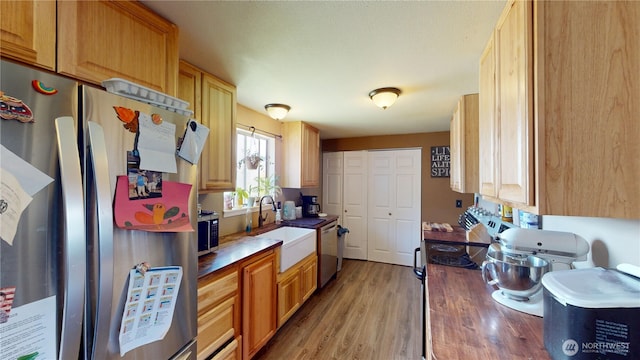 6 Elgin Way, Oroville, WA 98844 - kitchen with appliances with stainless steel finishes, a sink, and light wood-style floors