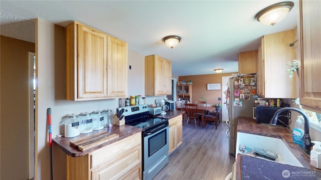 6 Elgin Way, Oroville, WA 98844 - kitchen with appliances with stainless steel finishes, light brown cabinets, dark countertops, and a sink