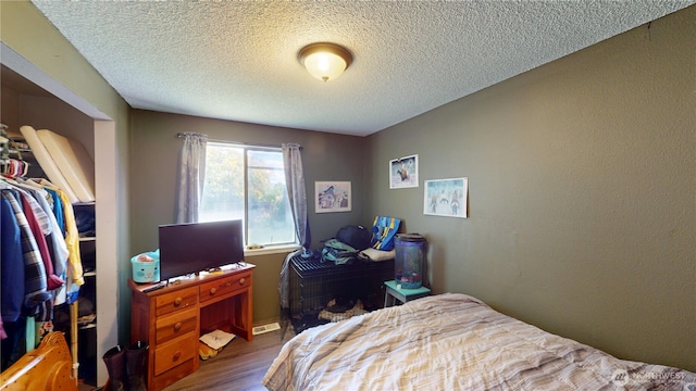 6 Elgin Way, Oroville, WA 98844 - bedroom featuring wood finished floors and a textured ceiling