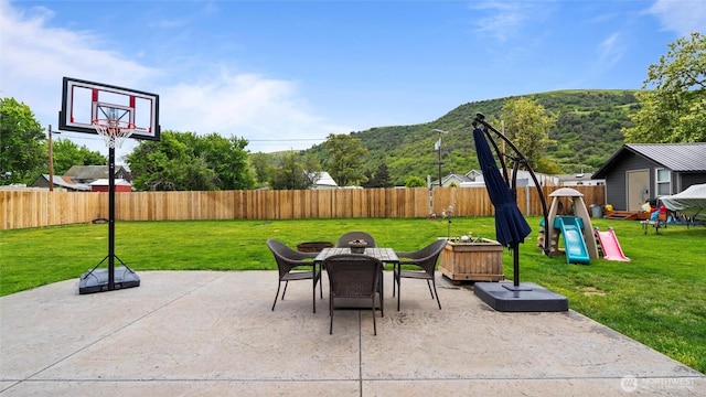 311 W Clay, Dayton, WA 99328 - view of patio / terrace featuring a mountain view, a playground, and outdoor dining area