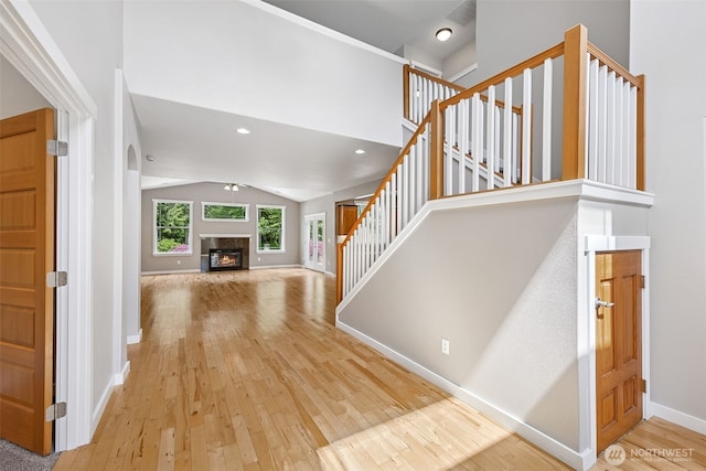 13123 320th Street Ct E, Graham, WA 98338 - foyer entrance with lofted ceiling, hardwood / wood-style flooring, stairs, baseboards, and a fireplace