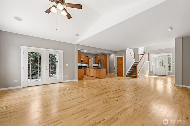 13123 320th Street Ct E, Graham, WA 98338 - unfurnished living room with light wood-style floors, stairway, healthy amount of natural light, ceiling fan, and lofted ceiling