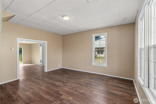 1109 River St, Hoquiam, WA 98550 - unfurnished room with healthy amount of natural light, a drop ceiling, dark wood-style flooring, and baseboards