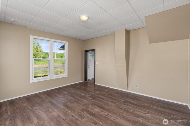 1109 River St, Hoquiam, WA 98550 - unfurnished room with a drop ceiling, baseboards, and dark wood-style flooring