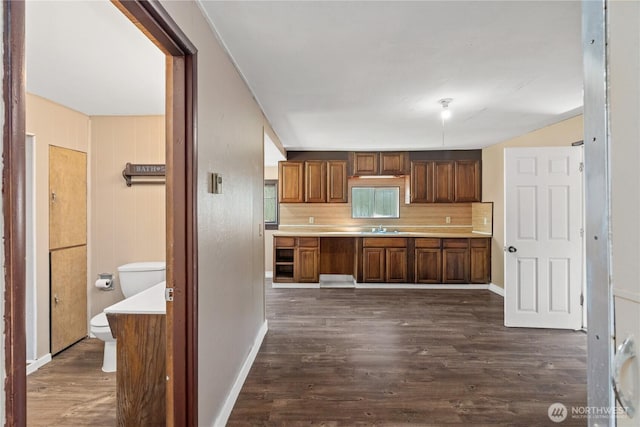 1109 River St, Hoquiam, WA 98550 - kitchen with light countertops, dark wood-style flooring, a sink, tasteful backsplash, and baseboards
