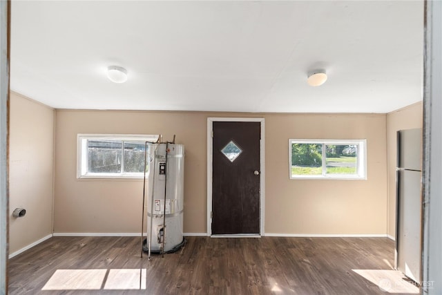 1109 River St, Hoquiam, WA 98550 - foyer featuring secured water heater, wood finished floors, and baseboards