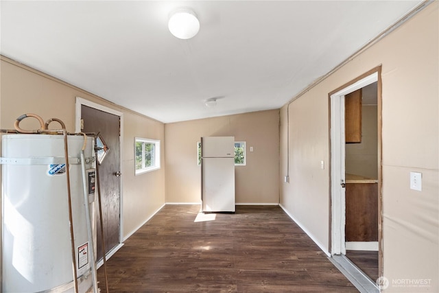 1109 River St, Hoquiam, WA 98550 - interior space with water heater, dark wood-style flooring, and baseboards