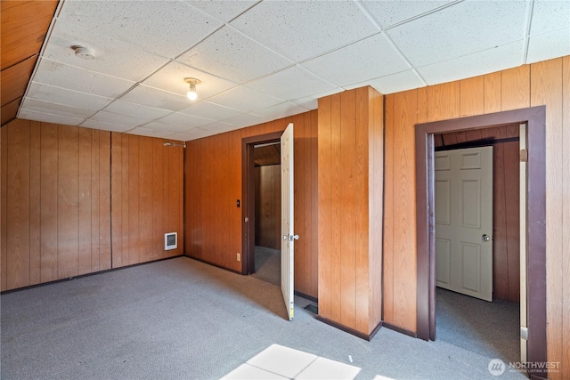 1109 River St, Hoquiam, WA 98550 - unfurnished bedroom with carpet, wood walls, and a drop ceiling