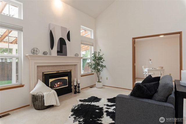 2433 18th St SE, Puyallup, WA 98374 - living area with high vaulted ceiling, carpet floors, a tile fireplace, and baseboards