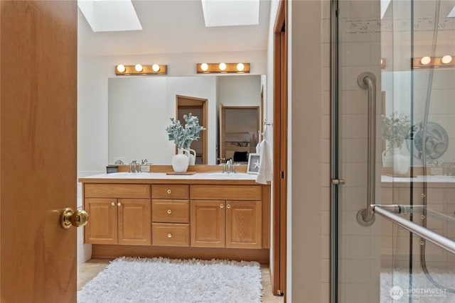 2433 18th St SE, Puyallup, WA 98374 - bathroom featuring a skylight, double vanity, and tiled shower