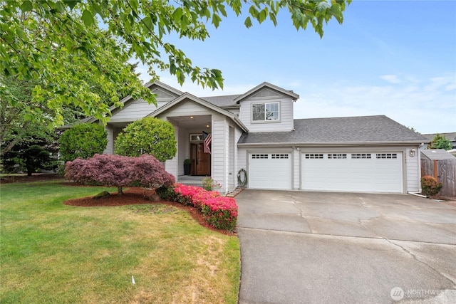 2433 18th St SE, Puyallup, WA 98374 - view of front of house with concrete driveway, an attached garage, and roof with shingles