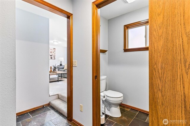 16515 126th Ave NE, Woodinville, WA 98072 - bathroom with stone tile floors, baseboards, and toilet
