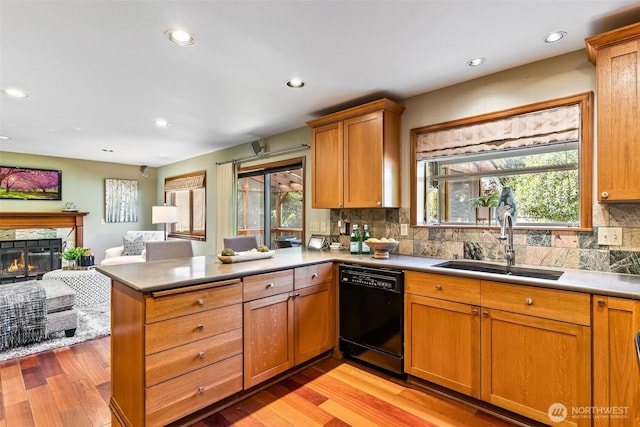16515 126th Ave NE, Woodinville, WA 98072 - kitchen featuring black dishwasher, a sink, open floor plan, a peninsula, and light wood-type flooring