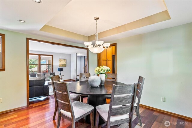 16515 126th Ave NE, Woodinville, WA 98072 - dining space with a chandelier, a raised ceiling, wood finished floors, baseboards, and recessed lighting