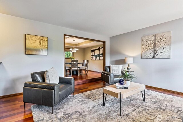 16515 126th Ave NE, Woodinville, WA 98072 - living room featuring a chandelier, wood finished floors, and baseboards
