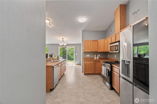 138 Stamper Rd, Elma, WA 98541 - kitchen with appliances with stainless steel finishes, a sink, a chandelier, and light countertops