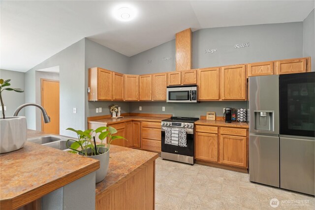 138 Stamper Rd, Elma, WA 98541 - kitchen featuring stainless steel appliances, light countertops, a sink, and high vaulted ceiling
