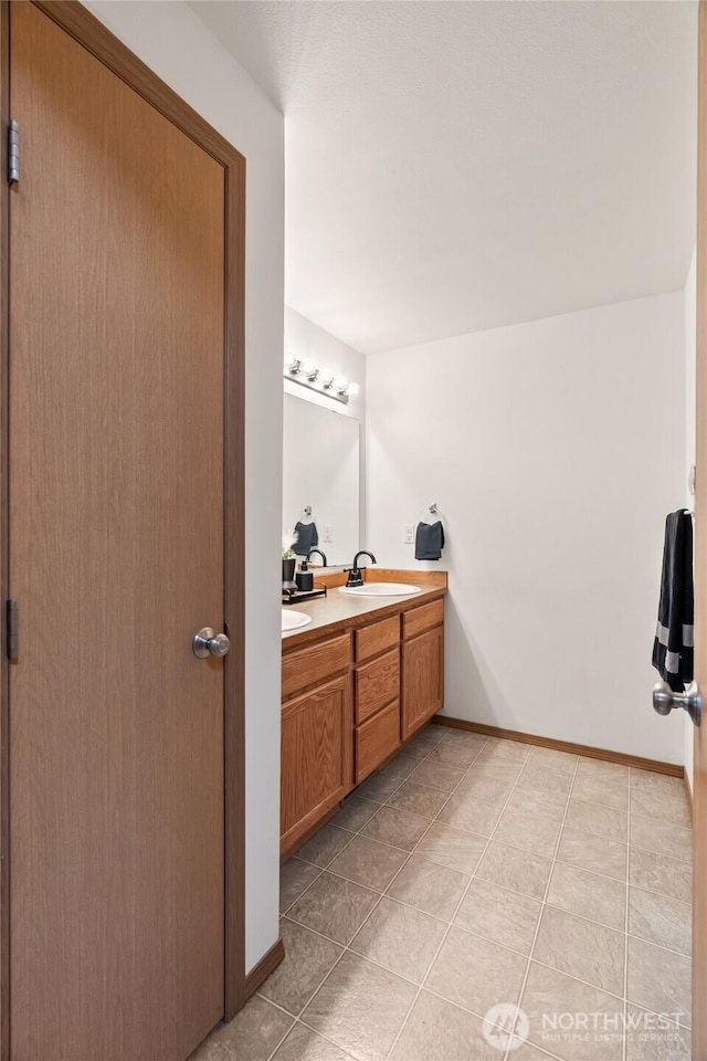 138 Stamper Rd, Elma, WA 98541 - bathroom featuring double vanity, baseboards, and tile patterned flooring