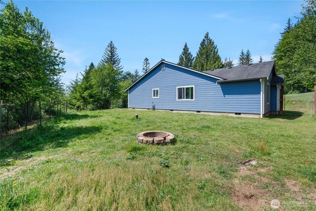 138 Stamper Rd, Elma, WA 98541 - view of side of property with an outdoor fire pit, a yard, and a shingled roof