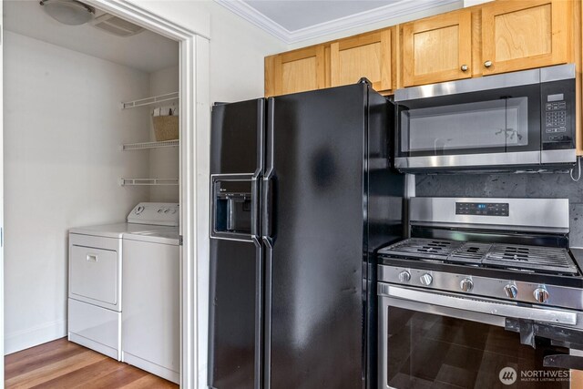 10309 Midvale Ave N Unit B, Seattle, WA 98133 - kitchen with appliances with stainless steel finishes, washing machine and clothes dryer, wood finished floors, ornamental molding, and baseboards