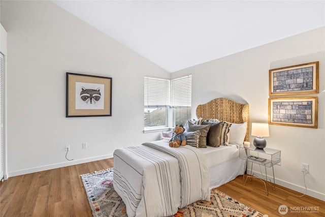 10309 Midvale Ave N Unit B, Seattle, WA 98133 - bedroom featuring vaulted ceiling, baseboards, and wood finished floors