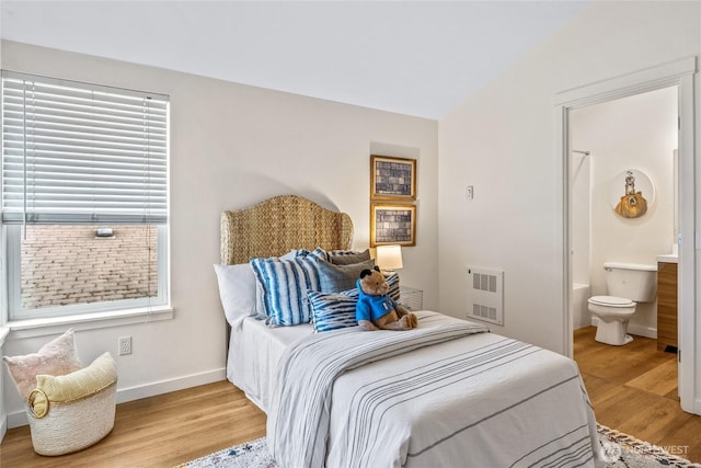 10309 Midvale Ave N Unit B, Seattle, WA 98133 - bedroom with light wood-type flooring, baseboards, ensuite bathroom, and heating unit