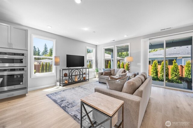 29215 217th Ct SE, Black Diamond, WA 98010 - living area with light wood finished floors, recessed lighting, and baseboards