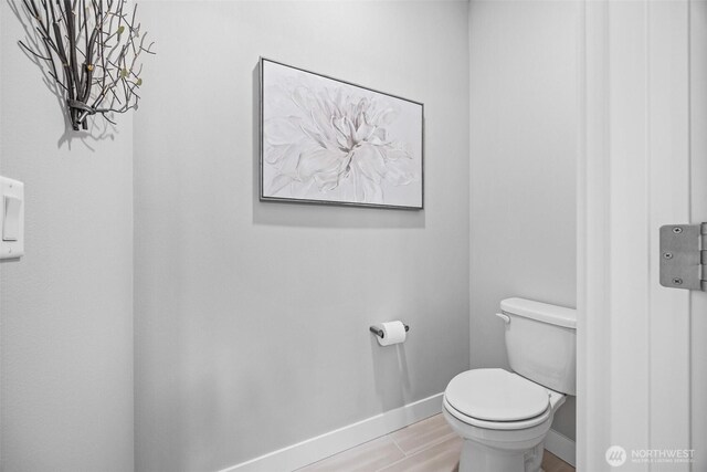 29215 217th Ct SE, Black Diamond, WA 98010 - bathroom with baseboards, toilet, and wood finished floors