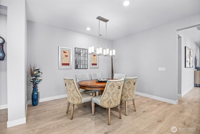 29215 217th Ct SE, Black Diamond, WA 98010 - dining room with light wood-style flooring, a chandelier, baseboards, and recessed lighting