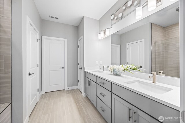 29215 217th Ct SE, Black Diamond, WA 98010 - full bath with double vanity, tiled shower, and baseboards