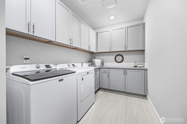 29215 217th Ct SE, Black Diamond, WA 98010 - laundry room featuring independent washer and dryer, cabinet space, and baseboards