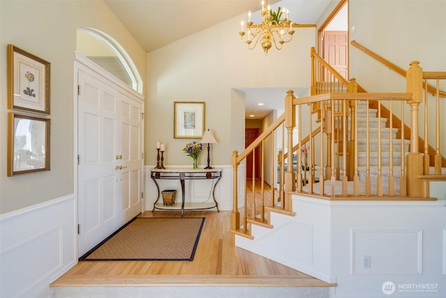 1875 Parkview Dr NE, Tacoma, WA 98422 - foyer entrance featuring wood finished floors, a chandelier, stairs, and high vaulted ceiling