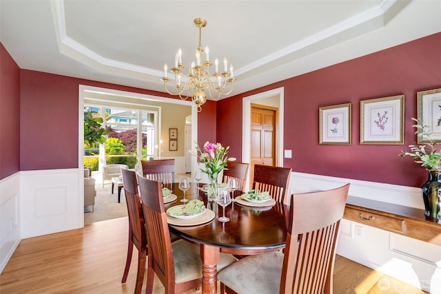 1875 Parkview Dr NE, Tacoma, WA 98422 - dining space featuring a tray ceiling, ornamental molding, light wood-style floors, a chandelier, and wainscoting
