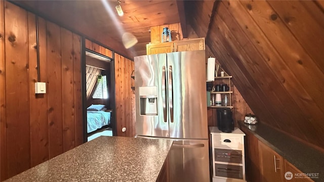 148 Seagate St SW, Ocean Shores, WA 98569 - kitchen with stainless steel refrigerator with ice dispenser, wooden walls, and vaulted ceiling
