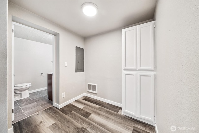 35120 E Kinsman Rd, Roy, WA 98580 - laundry area with electric panel, wood finished floors, and baseboards