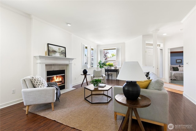 7417 53rd Street Ct W, University Place, WA 98467 - living room with a tile fireplace, dark wood-style floors, decorative columns, crown molding, and baseboards