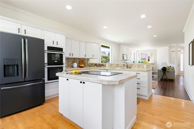 7417 53rd Street Ct W, University Place, WA 98467 - kitchen featuring black appliances, a center island, light countertops, a peninsula, and white cabinetry