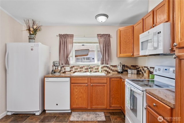 300 SW 7th Ave Unit 127, Battle Ground, WA 98604 - kitchen with white appliances, tasteful backsplash, stone finish floors, ornamental molding, and brown cabinetry