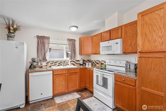 300 SW 7th Ave Unit 127, Battle Ground, WA 98604 - kitchen with white appliances, stone finish flooring, decorative backsplash, brown cabinets, and vaulted ceiling