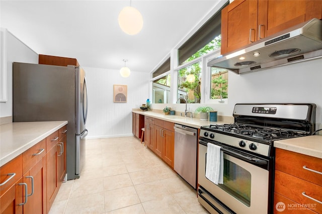 5 Wembley Ln, Mercer Island, WA 98040 - kitchen with appliances with stainless steel finishes, under cabinet range hood, a sink, brown cabinetry, and vaulted ceiling