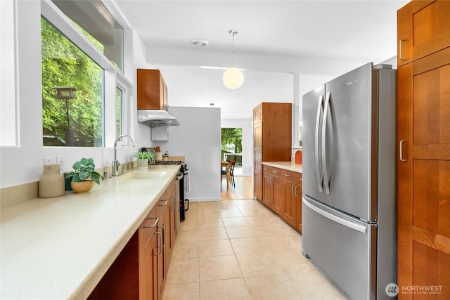 5 Wembley Ln, Mercer Island, WA 98040 - kitchen featuring stainless steel appliances, a sink, under cabinet range hood, light countertops, and brown cabinetry